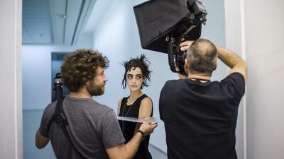 A model poses for a photographer backstage prior to the presentation of the Spring/Summer 2015 Ready to Wear Collection by Japanese designer Johji Yamamoto during the Paris Fashion Week on September 26, 2014. EPA