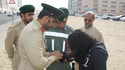 Col Saif Al Mazrouei fines a jaywalker in Dubai. Five people died after being run over between January and March. Courtesy Dubai Police