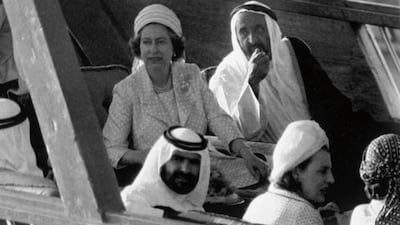 The queen sits with Sheikh Rashid on the Dubai Ruler's new dhow, as they are taken on a sightseeing tour of the emirate on February 26, 1979. AP