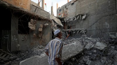 A man checks the family house of Palestinian assailant Islam Abu Humaid after it was demolished by Israeli forces in El Amari refugee camp in Ramallah, West Bank. Reuters