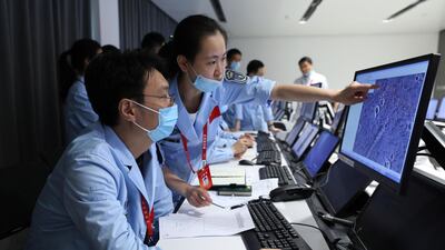 Technicians work at the Beijing Aerospace Control Center in Beijing May 15, 2021. Xinhua via AP