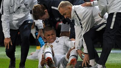 France forward Kylian Mbappe is helped by medical staff during their friendly against Iceland at Roudourou Stadium in Guingamp on Thursday. AFP