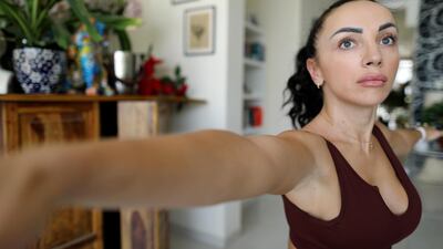 Kateryna Azar practising yoga at home.