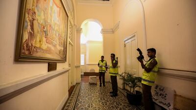 Officers inspect the palace for damage. EPA