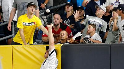 New York Yankees right fielder Aaron Judge makes a catch at the wall on a line drive hit by Cleveland Indians' Francisco Lindor during Game 3 of baseball's American League Division Series in New York. Kathy Willens / AP Photo