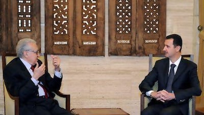 Syrian president Bashar Al Assad, right, meets with international envoy to Syria Lakhdar Brahimi in Damascus yesterday. Mr Assad has been warned not to use chemical weapons.