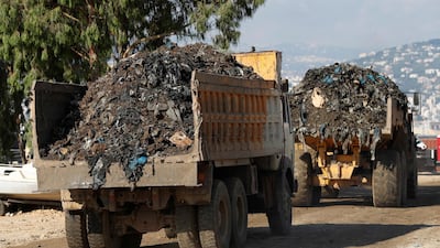 Trucks carry garbage to a new land reclamation site in Bourj Hammoud, east of Beirut, Lebanon. Hussein Malla / AP