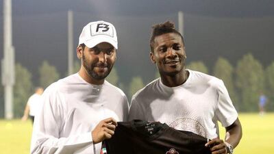 New Al Ahli signing Asamoah Gyan is seen with chairman Abdullah Al Naboodah last Wednesday. Photo Courtesy / Al Ahli