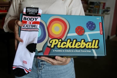 Jennifer Young, owner of Alair Gift Shop in Seattle, says pickleball products are a popular Father's Day gift. AP
