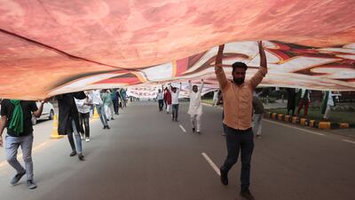 Indian Youth Congress activists hold a huge banner as they take part in a protest march in New Delhi. EPA