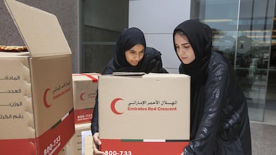 Aisha Al Mazrouei and Amal Ibrahim carry donation boxes for collection. Students in Petroleum Institute’s Academic Bridge Programme collected 1,885 kilogrammes of clothes for charity in cooperation with the Emirates Red Crescent. Mona Al Marzooqi/ The National