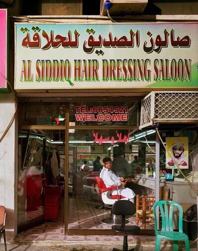 The photographer seeks out the older parts of Abu Dhabi, such as the Al Siddiq Hair Salon. Photo by Andrew Moore