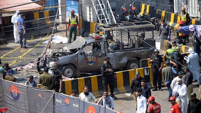 Officials examine the site of the bomb blast. EPA
