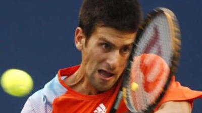 Novak Djokovic of Serbia returns a shot to Frank Dancevic of Canada at the Rogers Cup tournament in Toronto.
