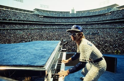 Elton John wearing a bejewelled baseball kit in 1975. Terry O’Neill/ Iconic Images