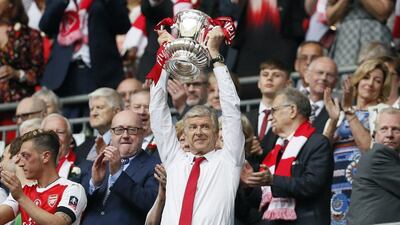 Arsene Wenger lifts the FA Cup after masterminding Arsenal's victory in the final over Chelsea. Kirsty Wigglesworth / AP Photo