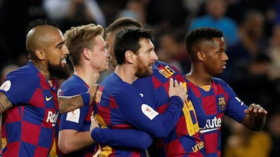 Lionel Messi celebrates scoring Barelona's third goal with teammates against Leganes. Reuters
