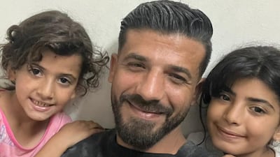 Maher Haboush with his daughters in Gaza city.