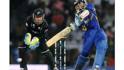 Tillakaratne Dilshan, right, surpassed Jonathan Trott as the World Cup's leading run-scorer with his 73 yesterday. Lakruwan Wanniarachchi / AFP