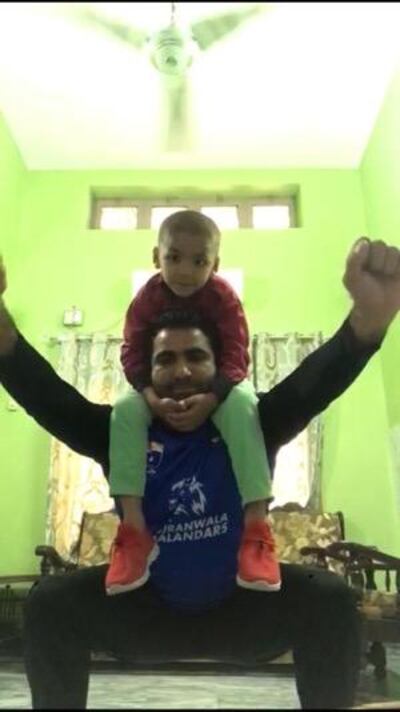 UAE spinner Sultan Ahmed performs squats with his son Abdulbakar on his shoulders as he trains during isolation. Courtesy Sultan Ahmed