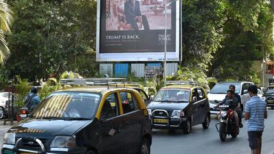 A billboard promotes the luxury residential apartment complex Trump Tower Mumbai. The US president-elect has substantial business interests in India. Indranil Mukherjee / AFP