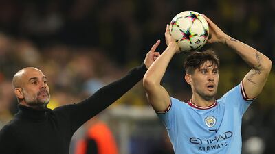 Manchester City manager Pep Guardiola gives instructions to defender John Stones. EPA