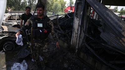 Security officials inspect the scene of the suicide bomb attack. EPA