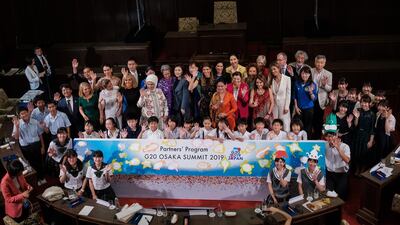 Akie Abe, the wife of the Japanese Prime Minister (C) poses with partners of the G20 leaders and a group of children for a family photo at G20 partners program during a symposium "Ocean a precious resource for our lives" at Osaka government in Osaka, Japan. Getty