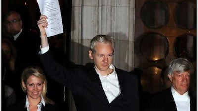 Julian Assange celebrates outside the High Court in central London after being granted bail yesterday.