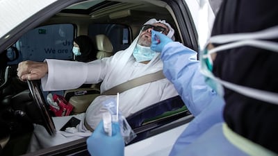 A drive-through patient gets tested for the coronavirus in Dubai. Victor Besa / The National