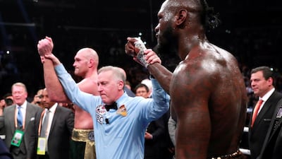 Deontay Wilder and Tyson Fury react after the fight. Reuters