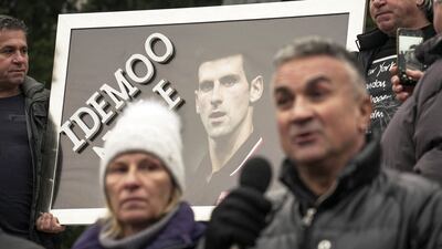 Serbian tennis player Novak Djokovic's father Srdjan Djokovic (R) speaks flanked by his wife Dijana Djokovic (L), as they take part in a rally in front of Serbia's National Assembly, in Belgrade. AFP