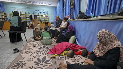 Palestinian families take shelter in a UN school in Gaza city on Thursday, after fleeing their homes in the town of Beit Lahia. Israel pounded Gaza and sent extra troops to the border as Palestinians fired barrages of rockets back. AFP / Mahmud Hams
