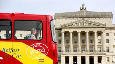 A tour bus makes its way past parliament buildings on the Stormont estate in Belfast, Northern Ireland. Reuters