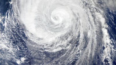 A handout photo made available by NASA Earth Observatory of a satellite image showing Typhoon Hagibis spinning toward the north-northwest over the western Pacific Ocean as its outer cloud bands near Japan. EPA