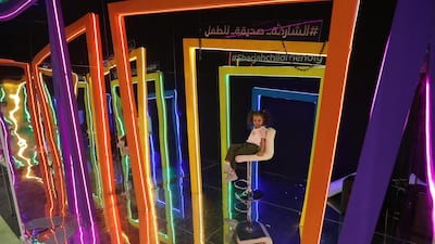 A child poses for a souvenir photo during the Sharjah Children's Reading Festival. EPA