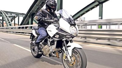 The hump ahead of the seat is not the traditional petrol tank but a storage area capable of stowing a medium-sized helmet.