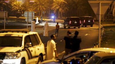 Policemen and EOD officials are seen at the bomb blast site where one police officer was killed in Budaiya west of Manama on August 28.Hamad I Mohammed / Reuters
