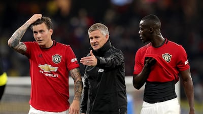Ole Gunnar Solskjaer (centre) talks with Victor Lindelof (left) and Eric Bailly. EPA