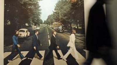 A visitor passes an oversized photo of Abbey Road during the opening of the Beatles Museum in Hamburg, Germany.