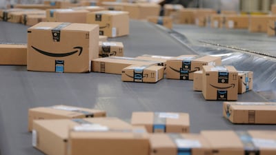 Packages emblazoned with Amazon logos travel along a conveyor belt inside of an Amazon warehouse. Reuters
