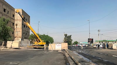 Iraqi security forces remove concrete blast walls that were cutting the streets in the protest site area of Baghdad, a day after calm was restored in the Iraqi capital. AP Photo