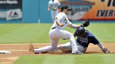 The Florida Marlins second baseman Dan Uggla, left, tags out Tampa Bay Rays' Carl Crawford.