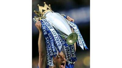 Chelsea's captain John Terry celebrates with the Barclays Premier League Trophy after their 8-0 victory over Wigan Athletic last year. Adrian Dennis / AFP