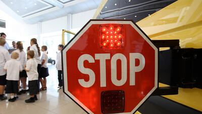 Motorists should halt at least five metres behind parked school buses to ensure pupil safety. Pawan Singh / The National