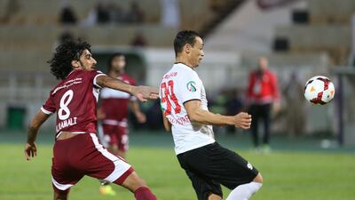Al Wahda's Hamdan Al Kamali, left, fights for possession against Al Jazira in a President's Cup match on Tuesday night. Delores Johnson/ The National