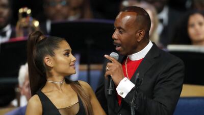 Bishop Charles H. Ellis, III, right, speaks with Ariana Grande after she performed during the funeral service for Aretha Franklin AP