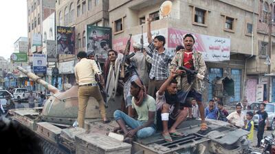 Militants loyal to Yemen’s exiled government ride atop a tank they seized from Houthi militiamen in the central city of Taez on August 17, 2015. Reuters