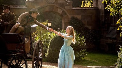 Lily James is Cinderella and Ben Chaplin is Cinderella‘s father in Disney’s live-action feature Cinderella, directed by Kenneth Branagh. Courtesy Walt Disney Productions