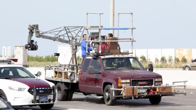 A camera crew sits on the back of a truck on Sheikh Zayed Street, near Sheikh Zayed Bridge, in Abu Dhabi. Mohammed Salmeen Al Neyadi /The National
